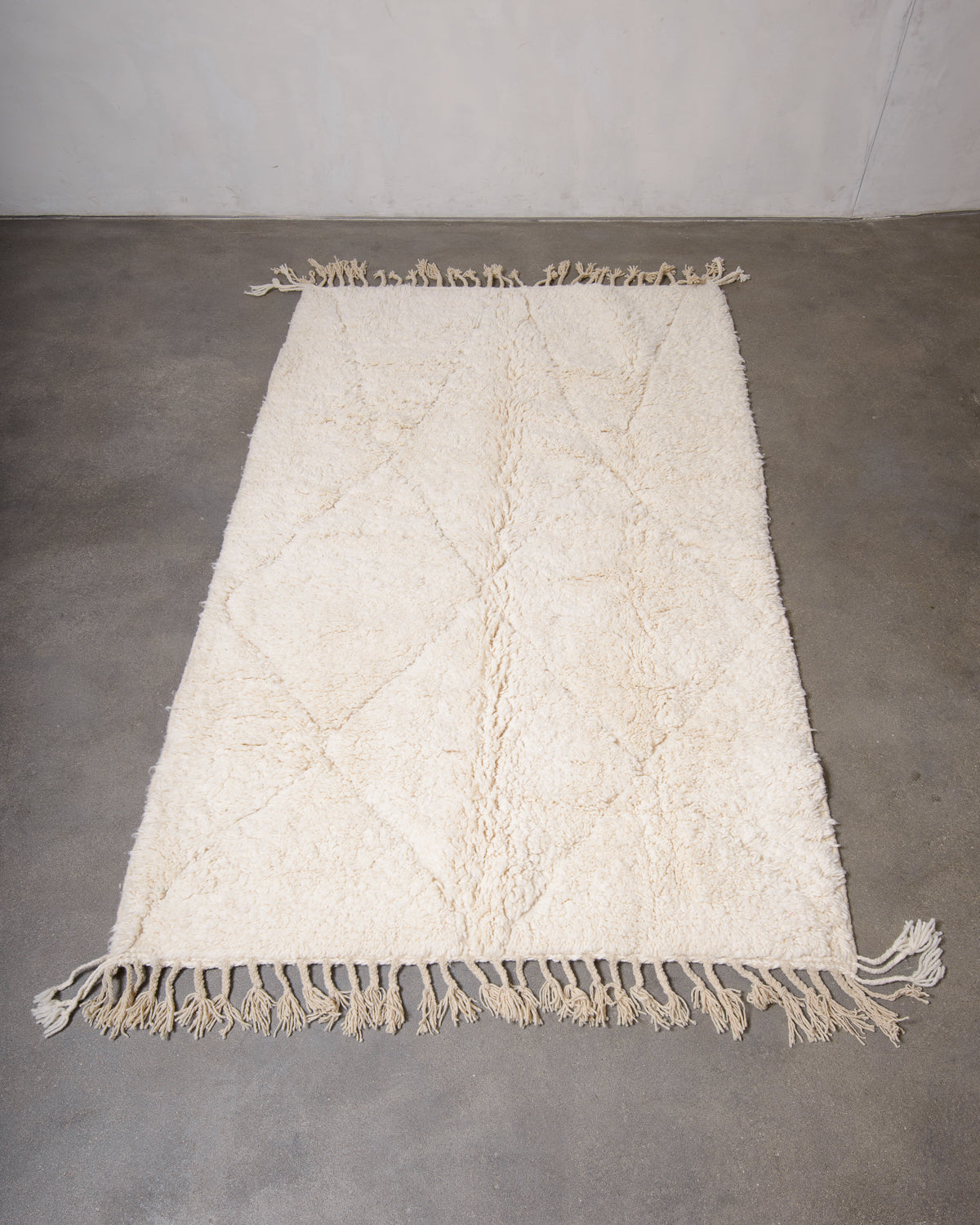 Modern, designer, handcrafted Berber rug from Morocco. Beniourain carpet with minimalist design, natural wool pile and a fluffy texture.